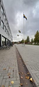 A picture of the university walkway showing the Swedish flags